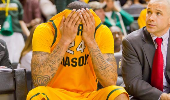 Ryan Pearson covers his head after fouling out of Saturday night's loss at VCU. (John Powell)